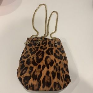 Faux leopard print bucket bag with gold chain straps